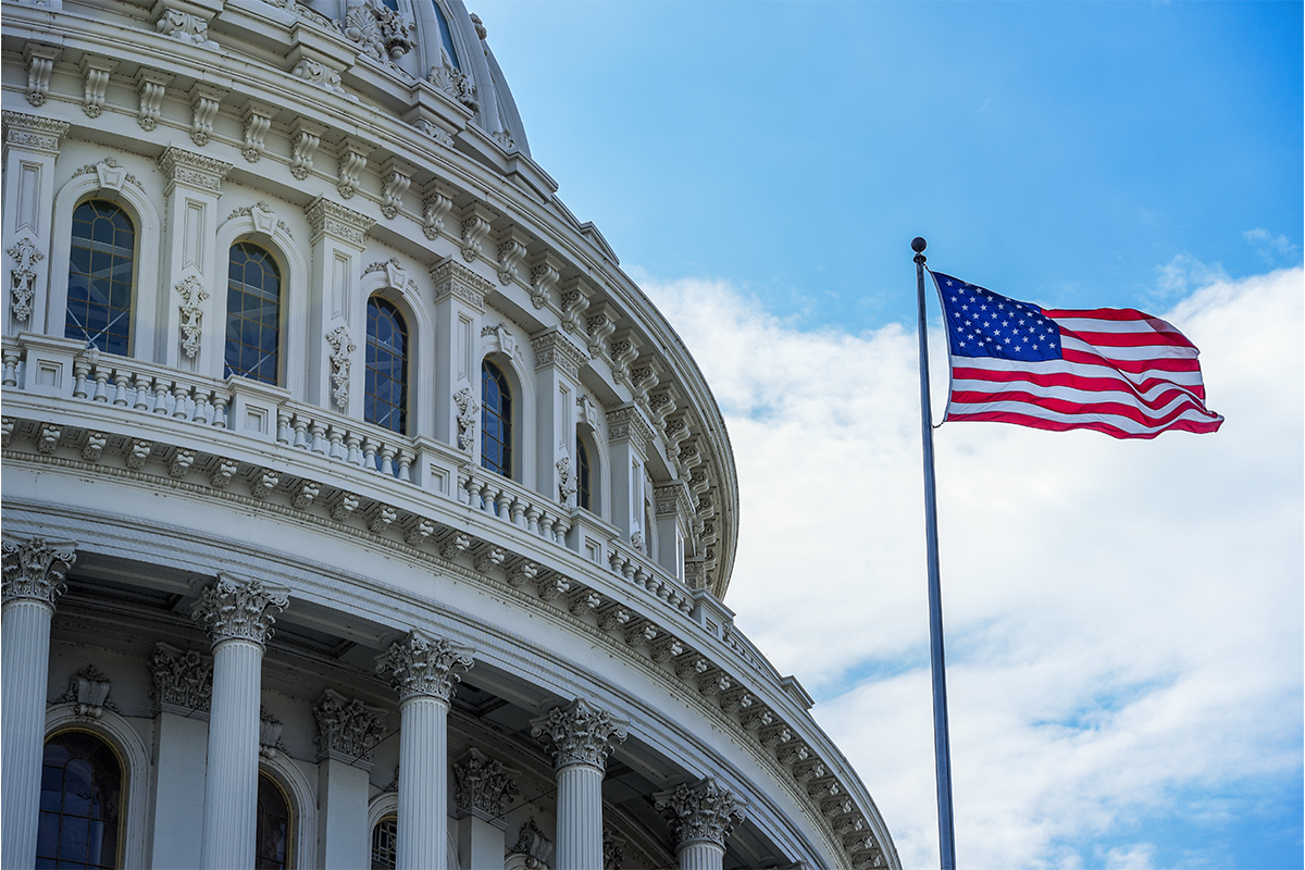 US Capitol with American flag flying in front of it