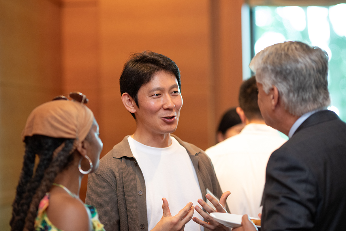 two faculty members talking during reception