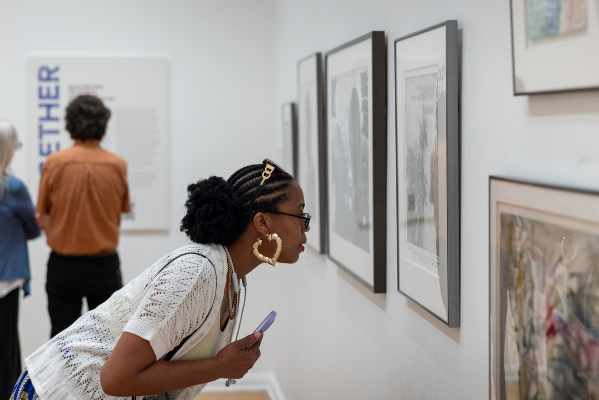 woman looking at art gallery