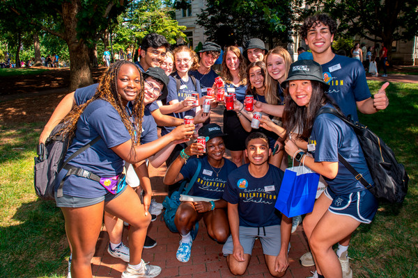 A group of students in Emory outfits posing together for a photo