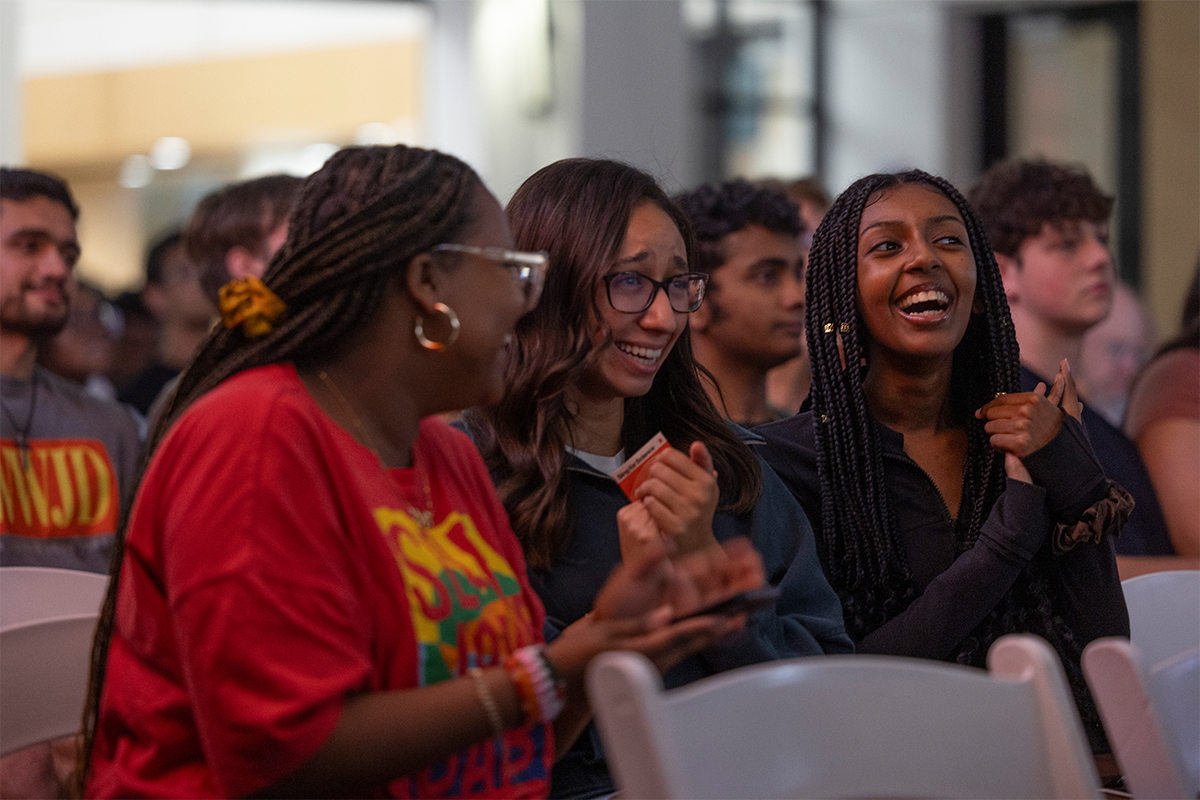 college age women clapping in audience