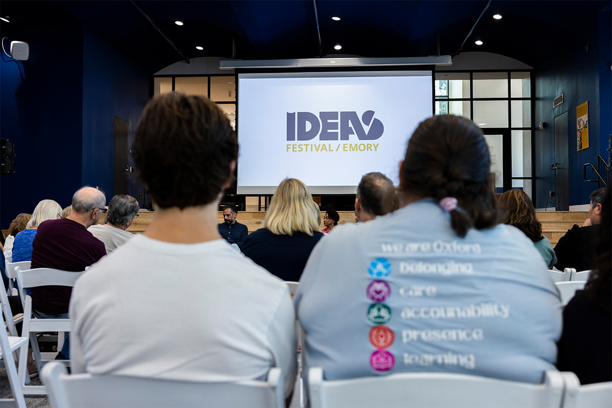 people in audience looking at screen that says Ideas Festival Emory