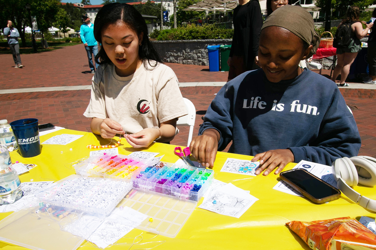 Two students doing crafts outside