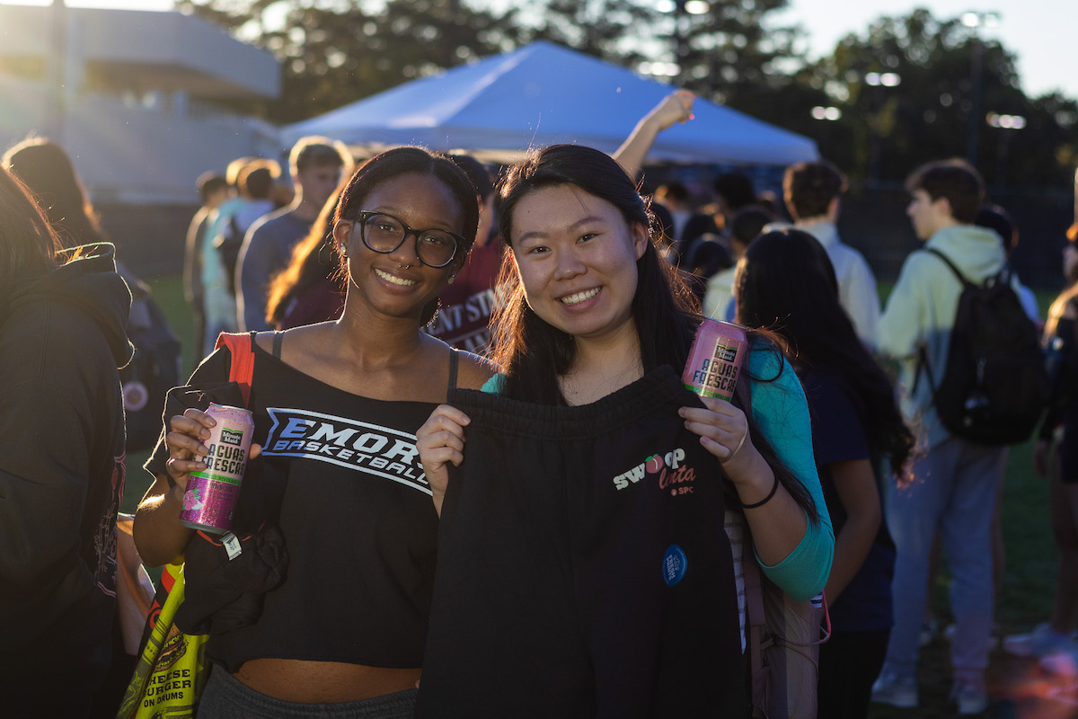 Two students with Emory merch