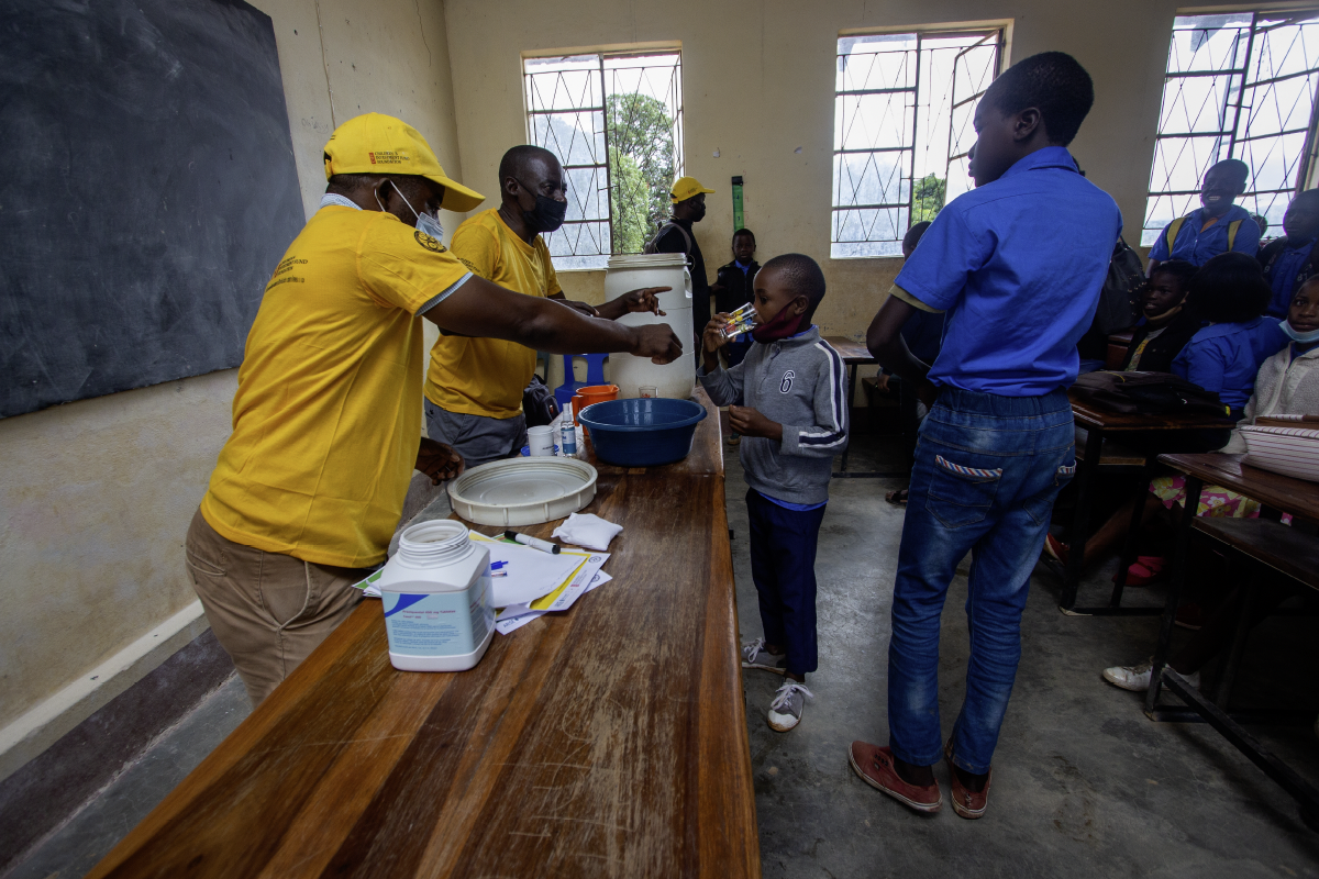 Children taking preventive medication in campaign against schistosomiasis in Mozambique