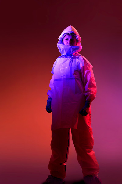 Woman in medical suit on pink background