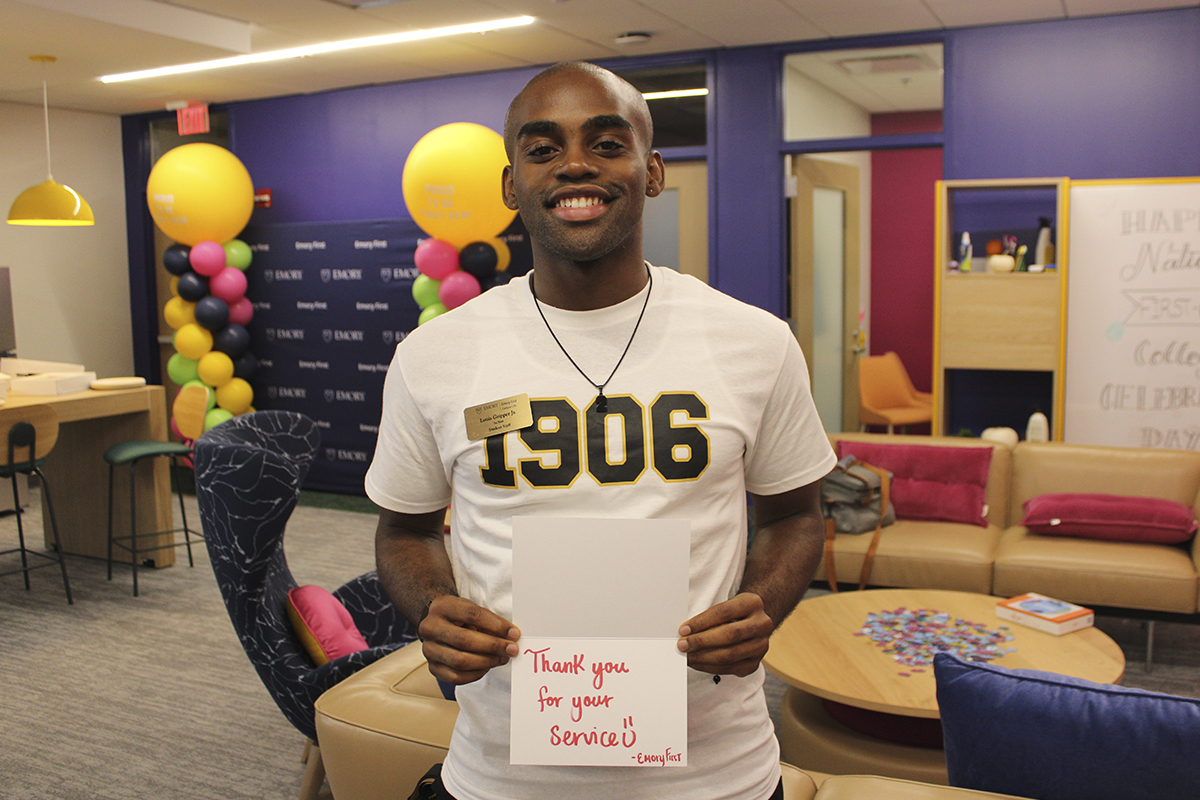 male college student with thank you sign for veterans