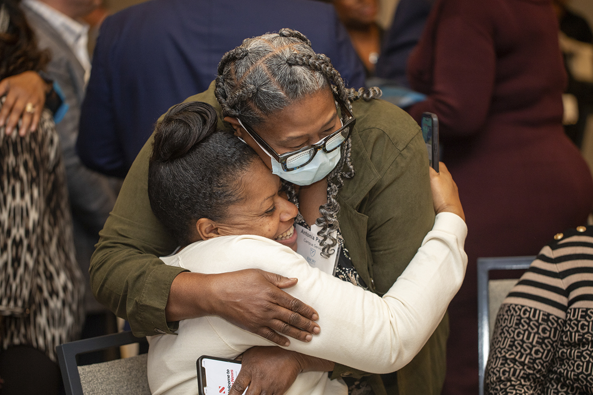 two women hugging in crowd