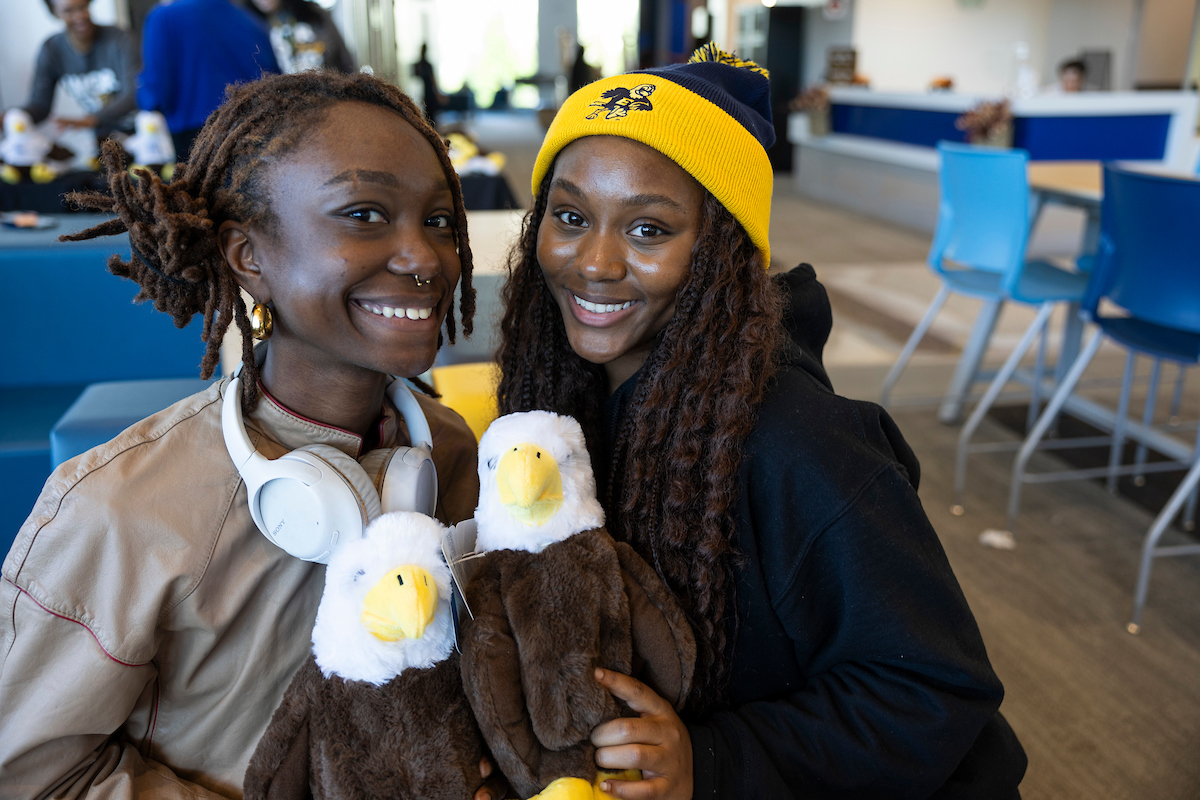 Students smile with Swoop plushies