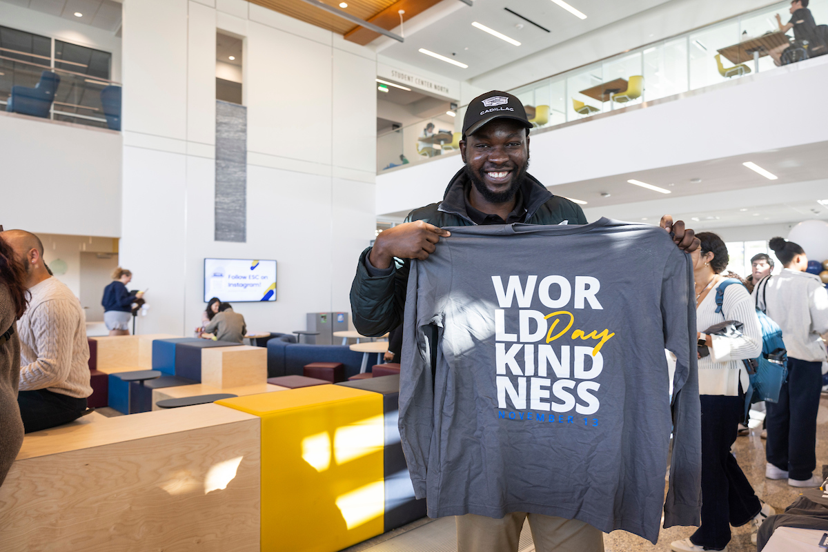 Person holding World Kindness Day shirt