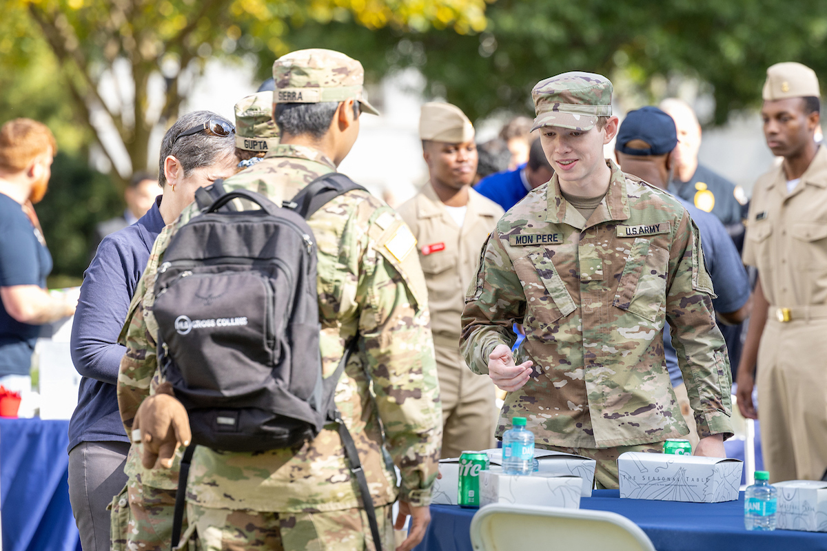 uniformed students grab boxed lunches