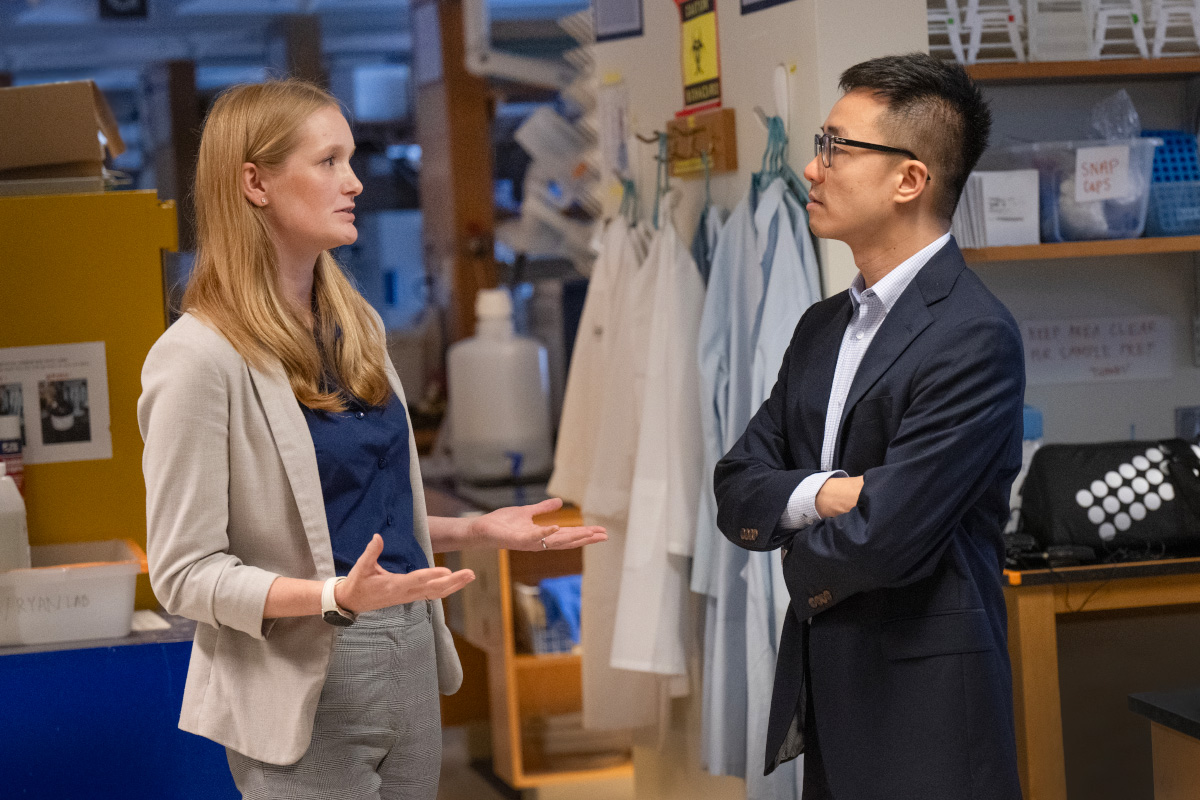 Female and male researchers talking in lab