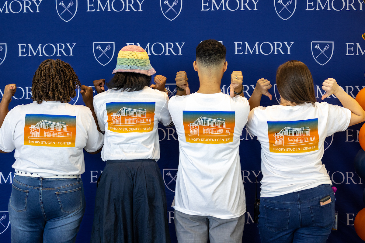 people posing with Emory shirts 