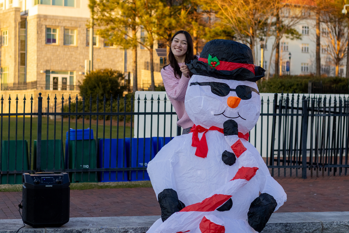 student with snowman inflatable 