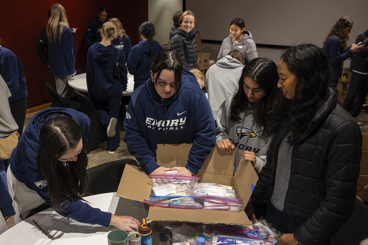 college students packing boxes for service project