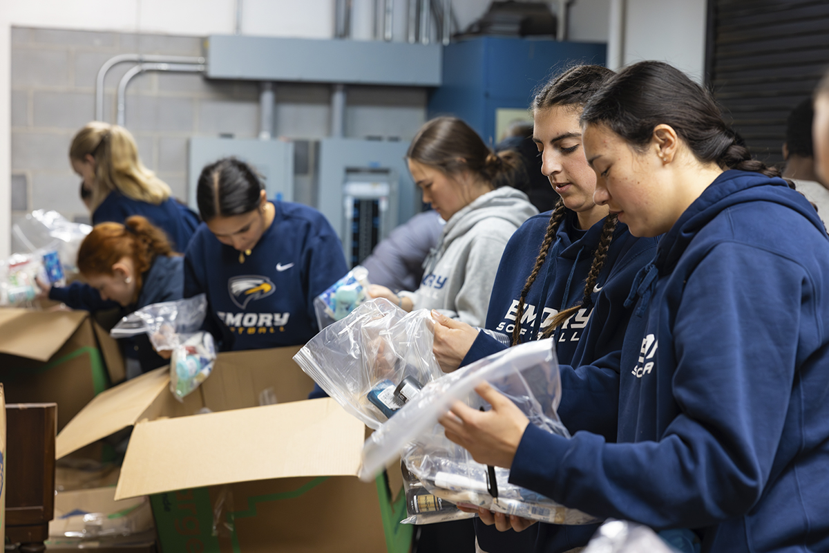 college students packing boxes for service project