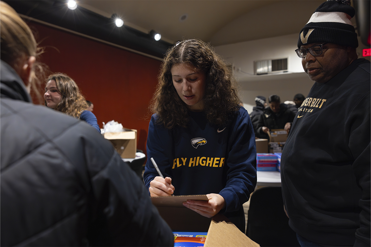 college students packing boxes for service project