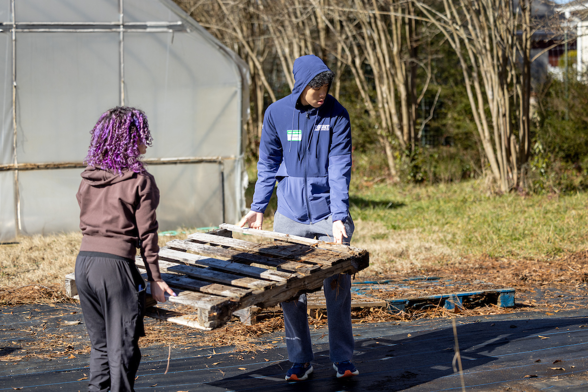 students carrying palette 