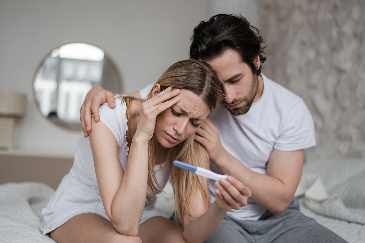 Woman and man upset over pregnancy test