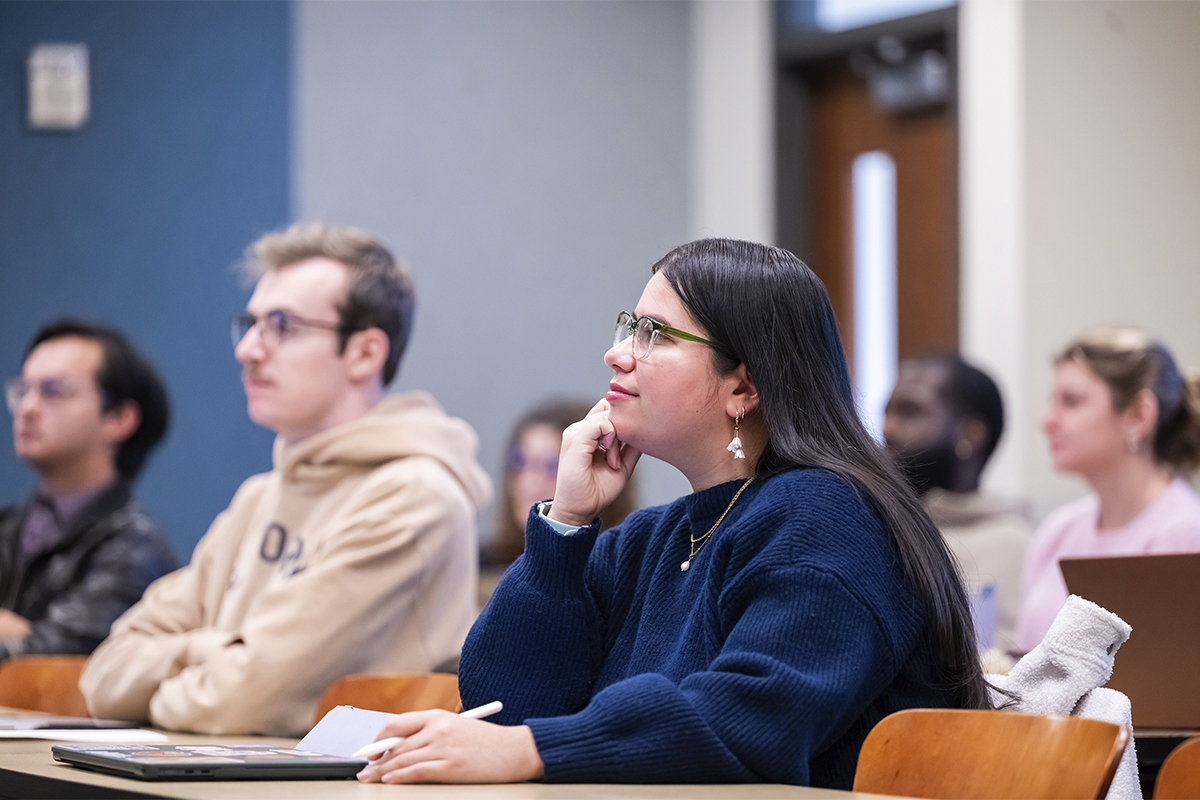 male and female college students sitting in class