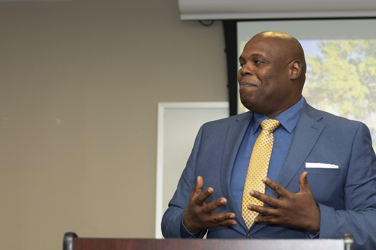 Latron Price speaking at podium