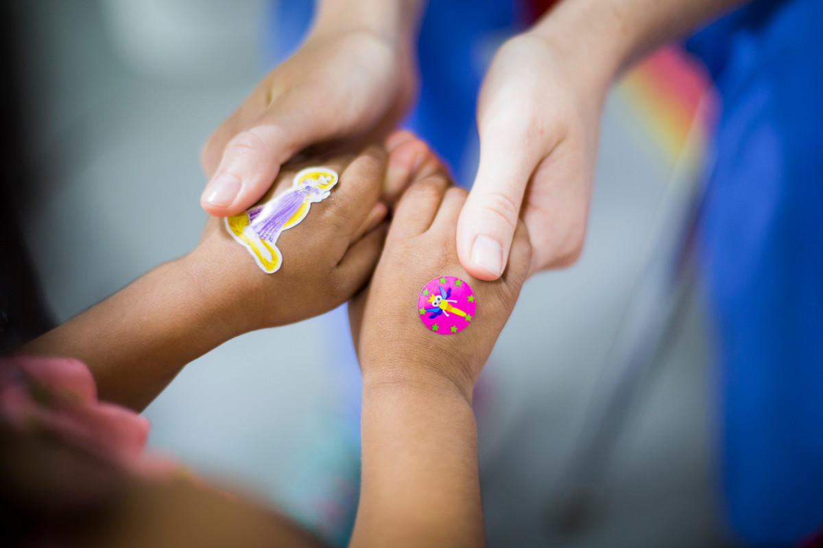 child holding hands of care worker