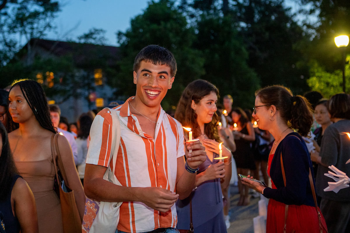 students holding candles at crossover 