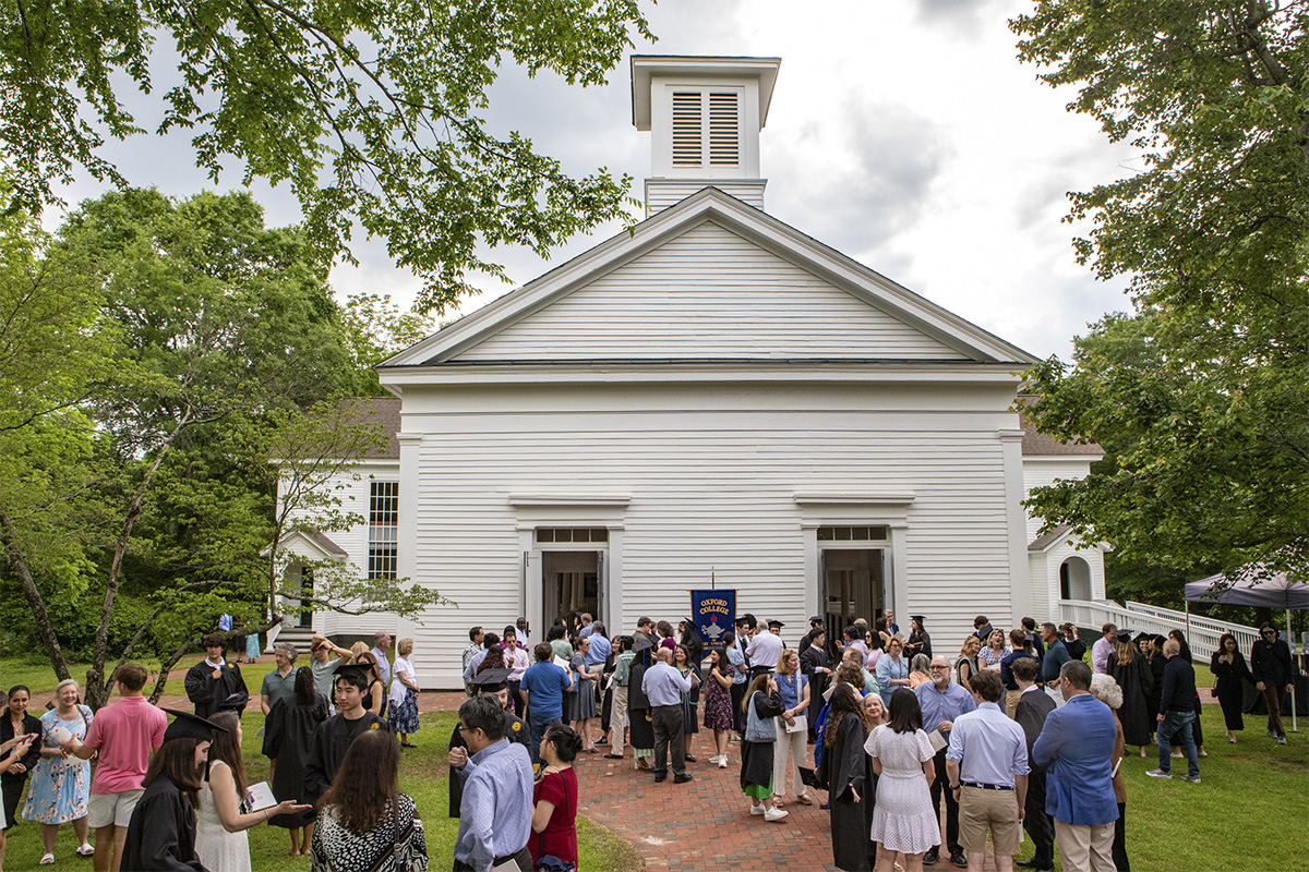 college students and families mingle outside church building