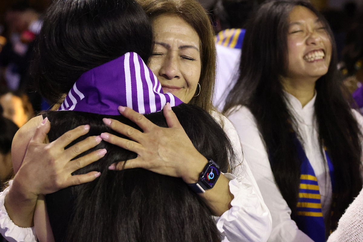 Parent hugging their graduate