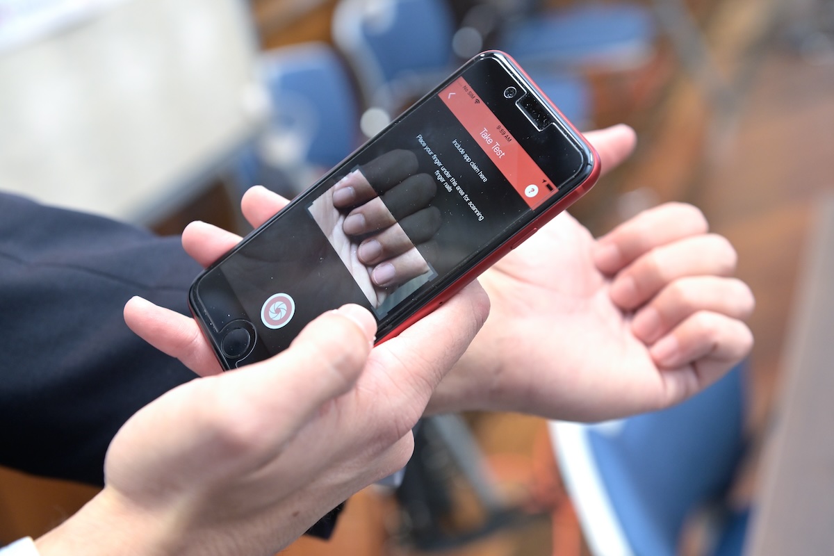 Smart phone taking a photo of fingers
