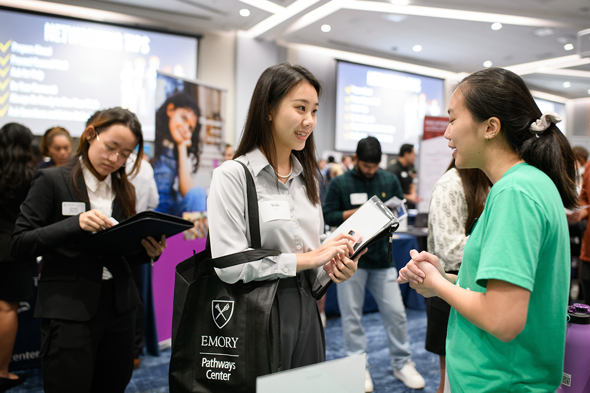 students in conversation with recruiter