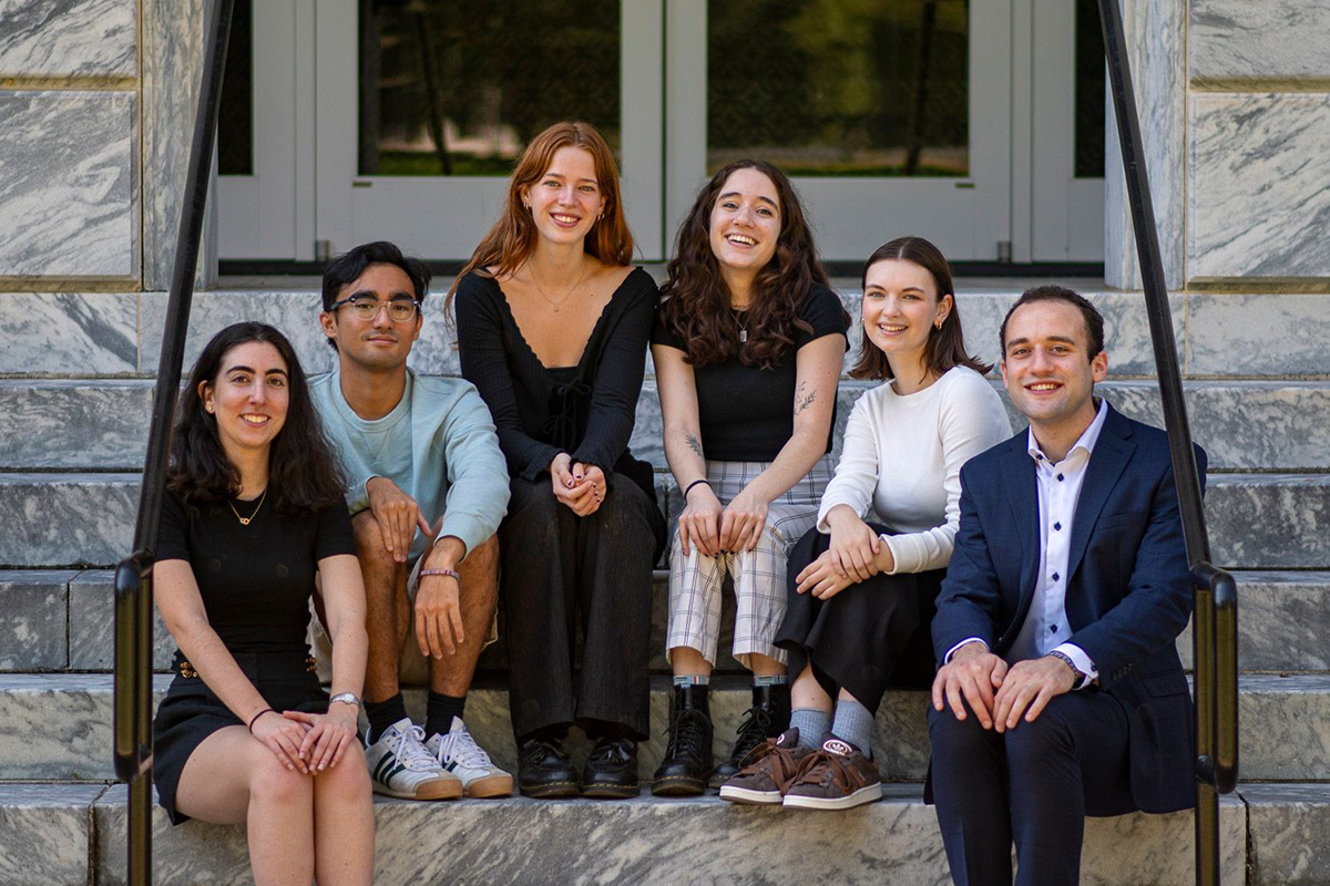 2024-25 editors sit on steps