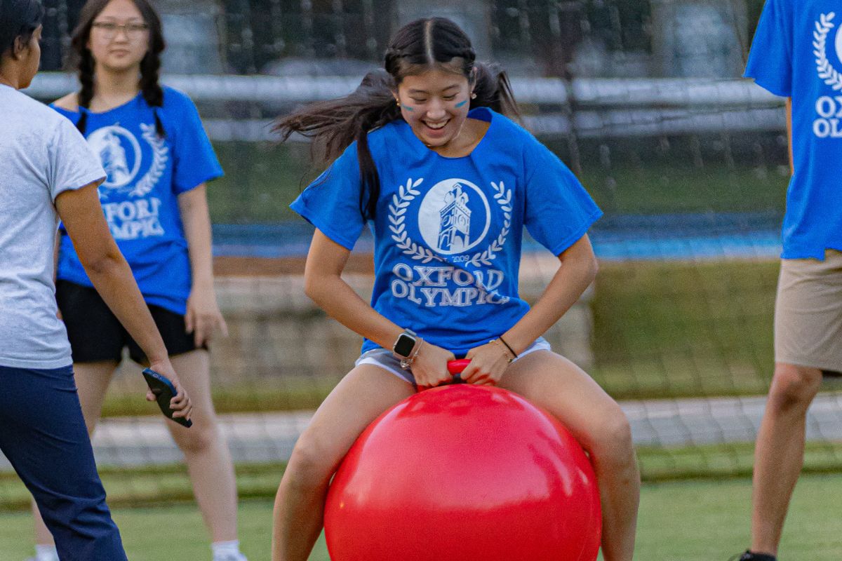 female student in blue t-shirt playing a game in the Oxford Olympics