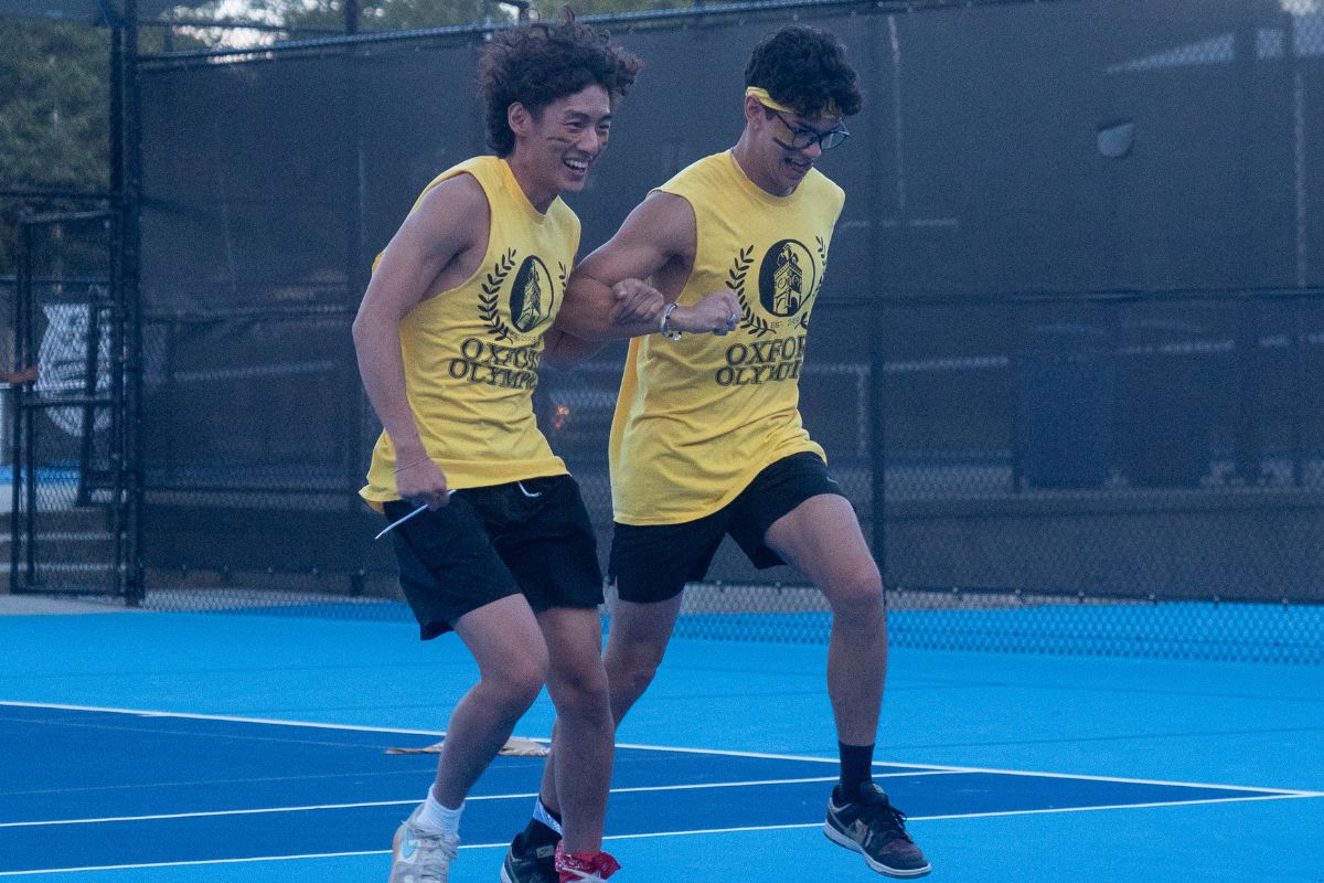 two men in yellow tshirts 