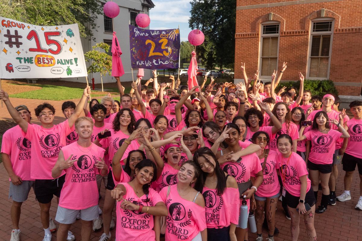group of students in pink t-shirts posing at the Oxford Olympics 