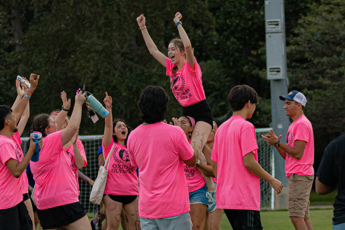 students in pink t-shirts playing a game in the Oxford Olympics