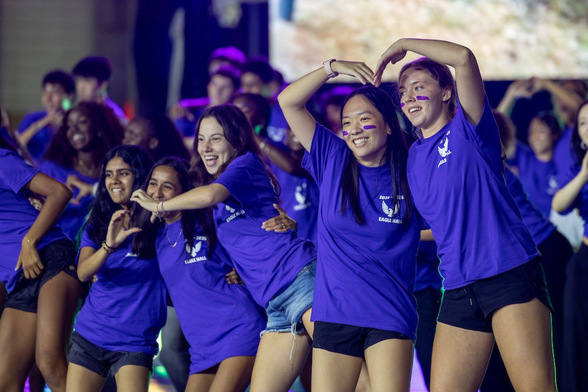 students in purple t-shirts dancing during Songfest 