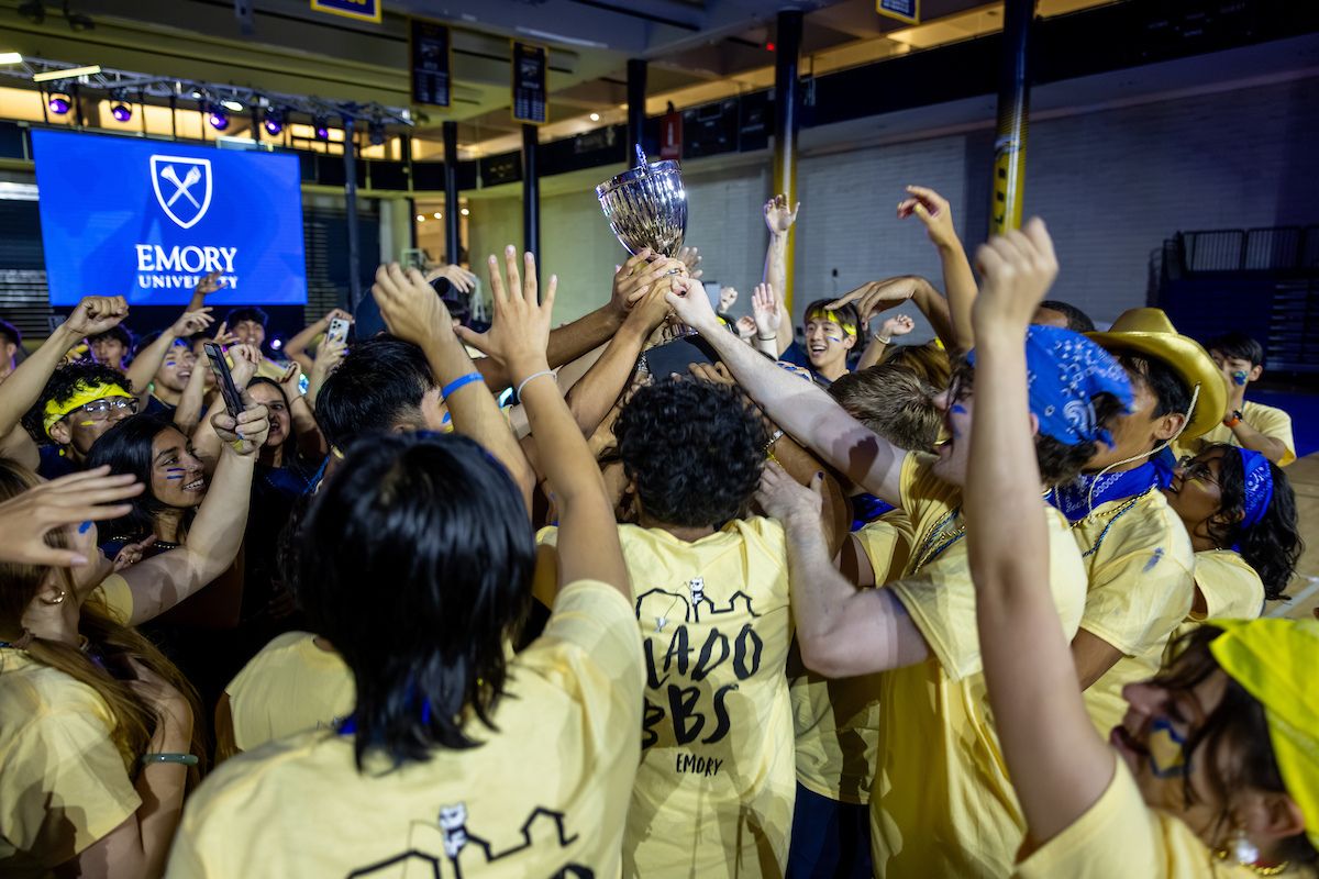 students holding the Songfest trophy 