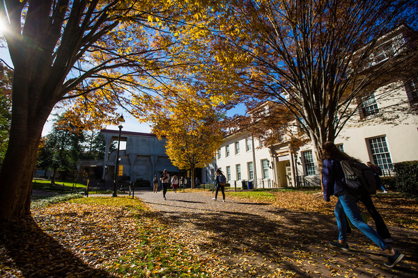 exterior photo of the Administration Building with students walking on a sunny day