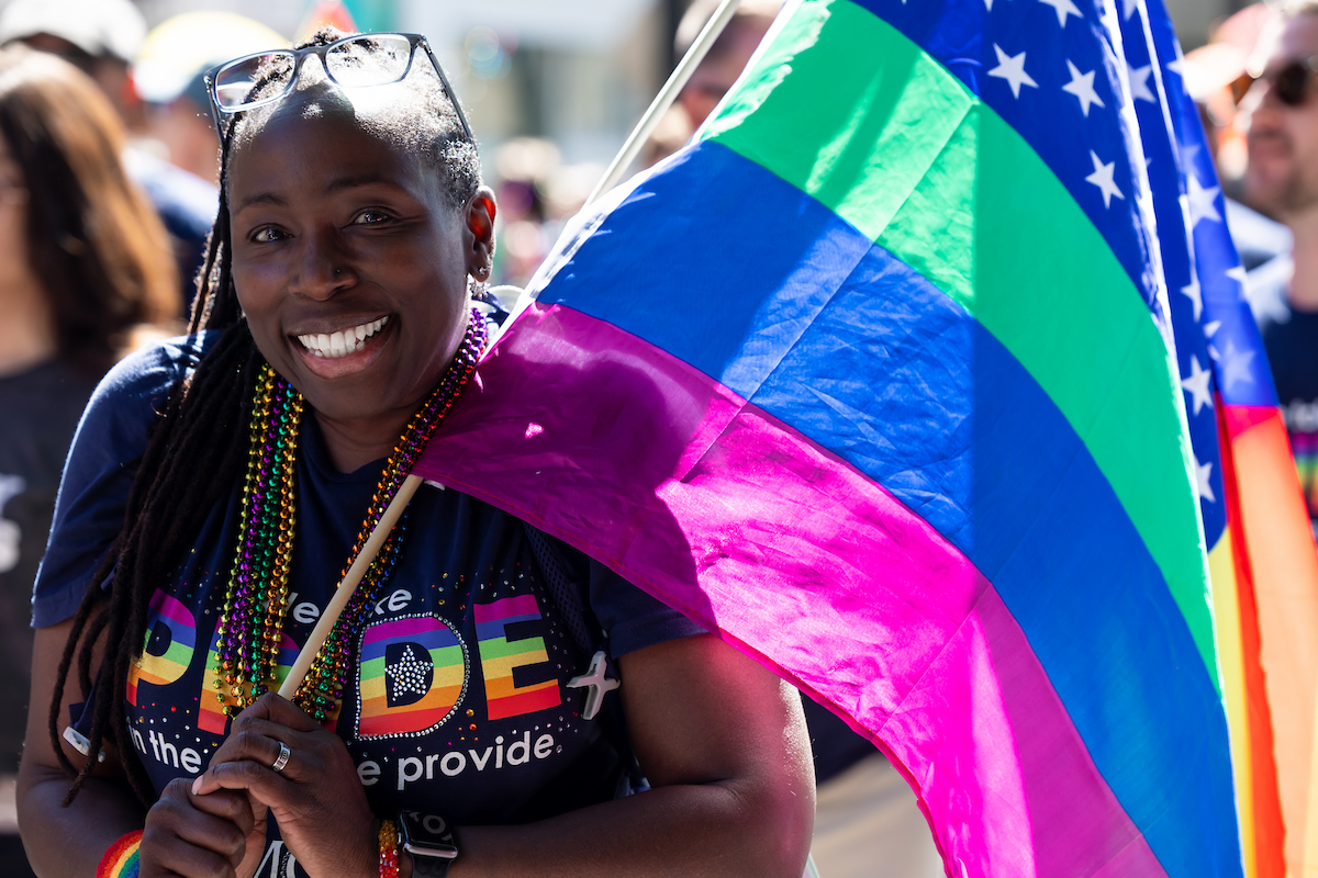 Woman holding rainbow flag