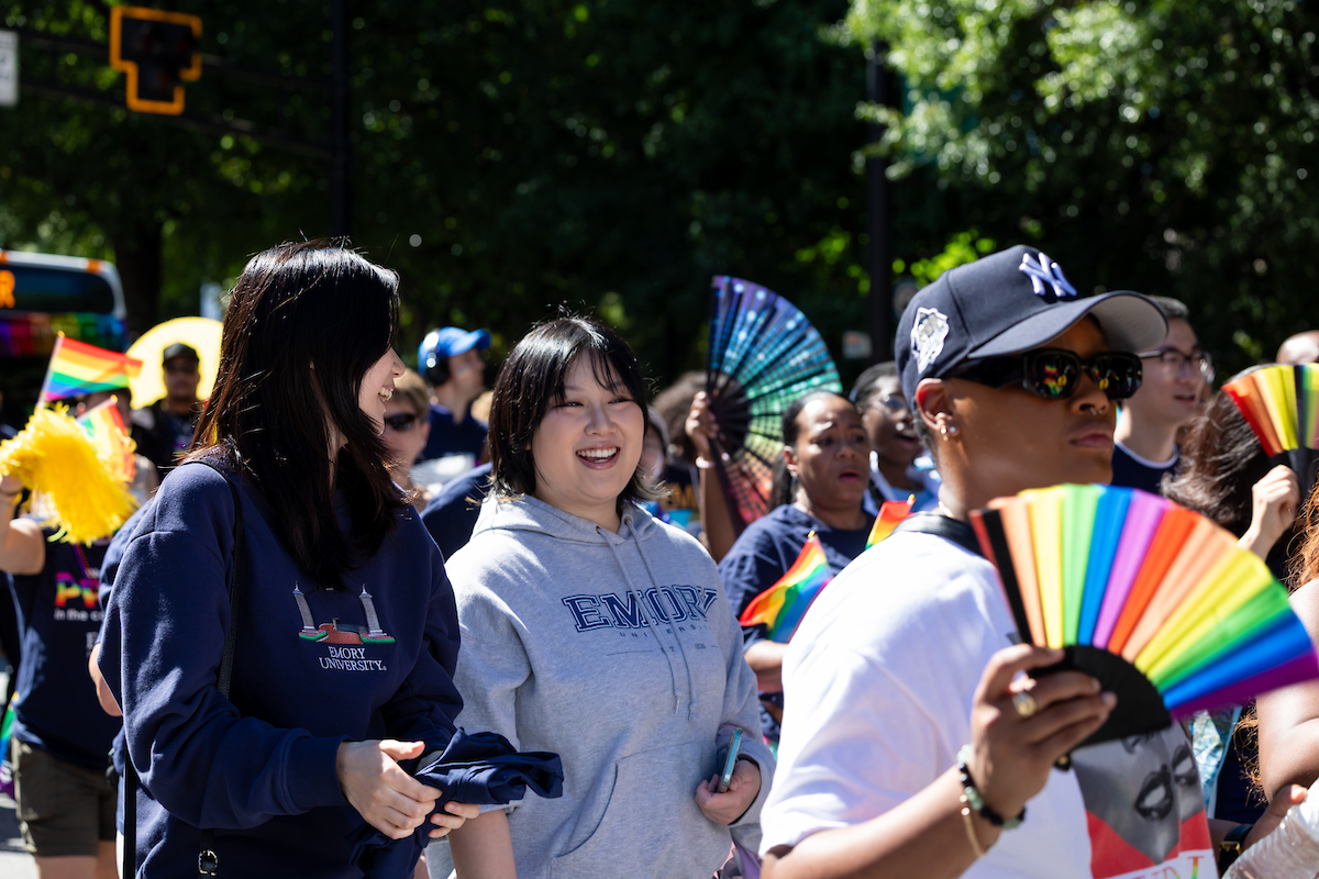 group walking with colorful fans