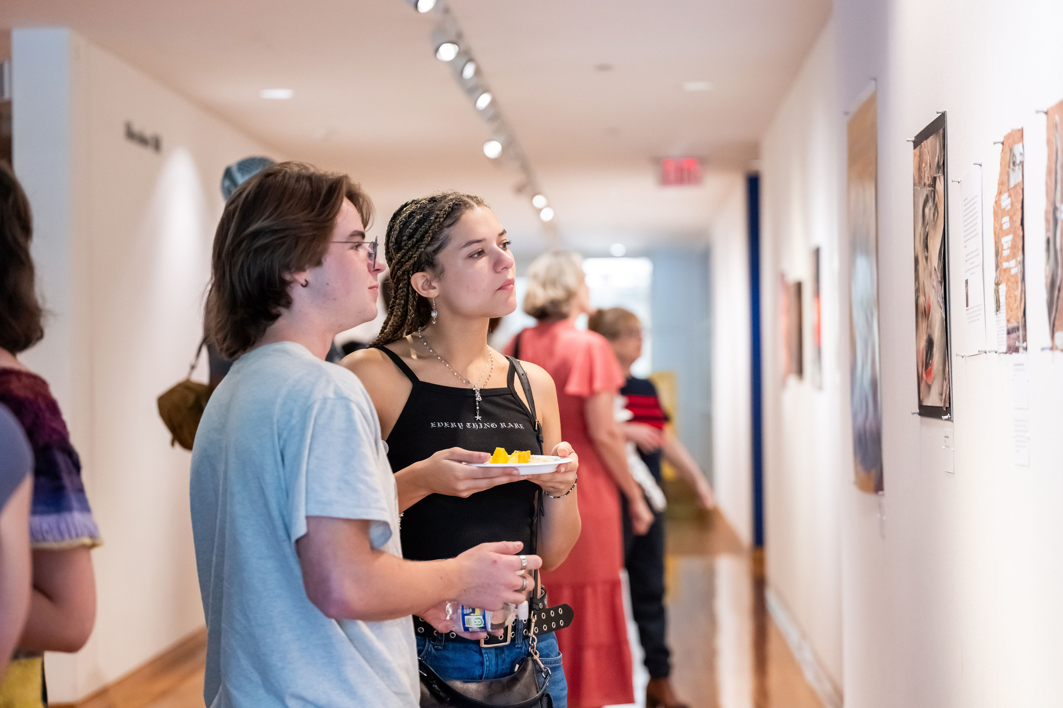 Two students looking at a piece of art