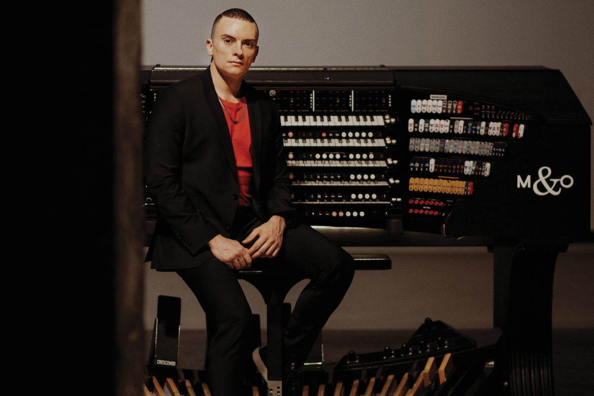 musician Cameron Carpenter sitting in front of an organ