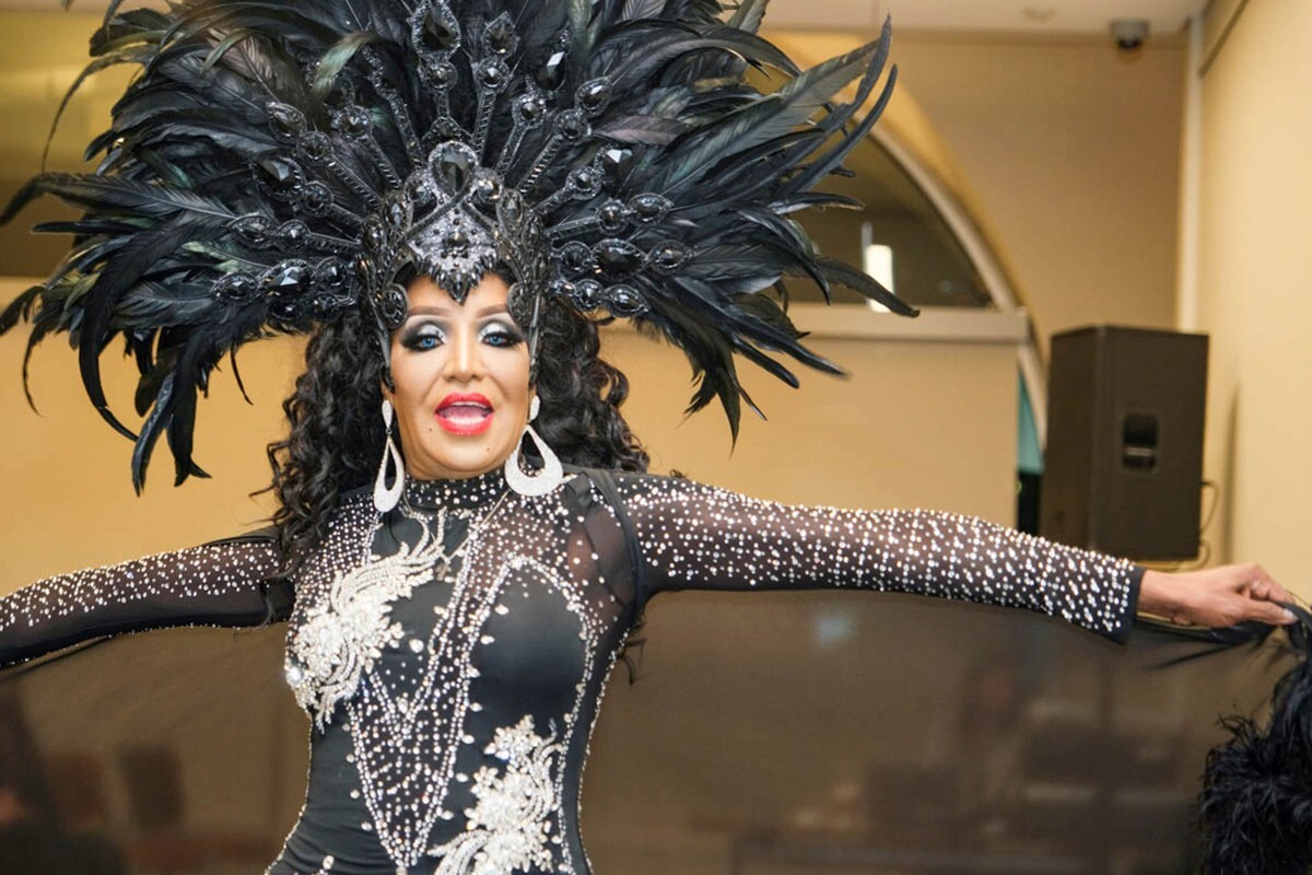 performer dressed in black headdress and costume