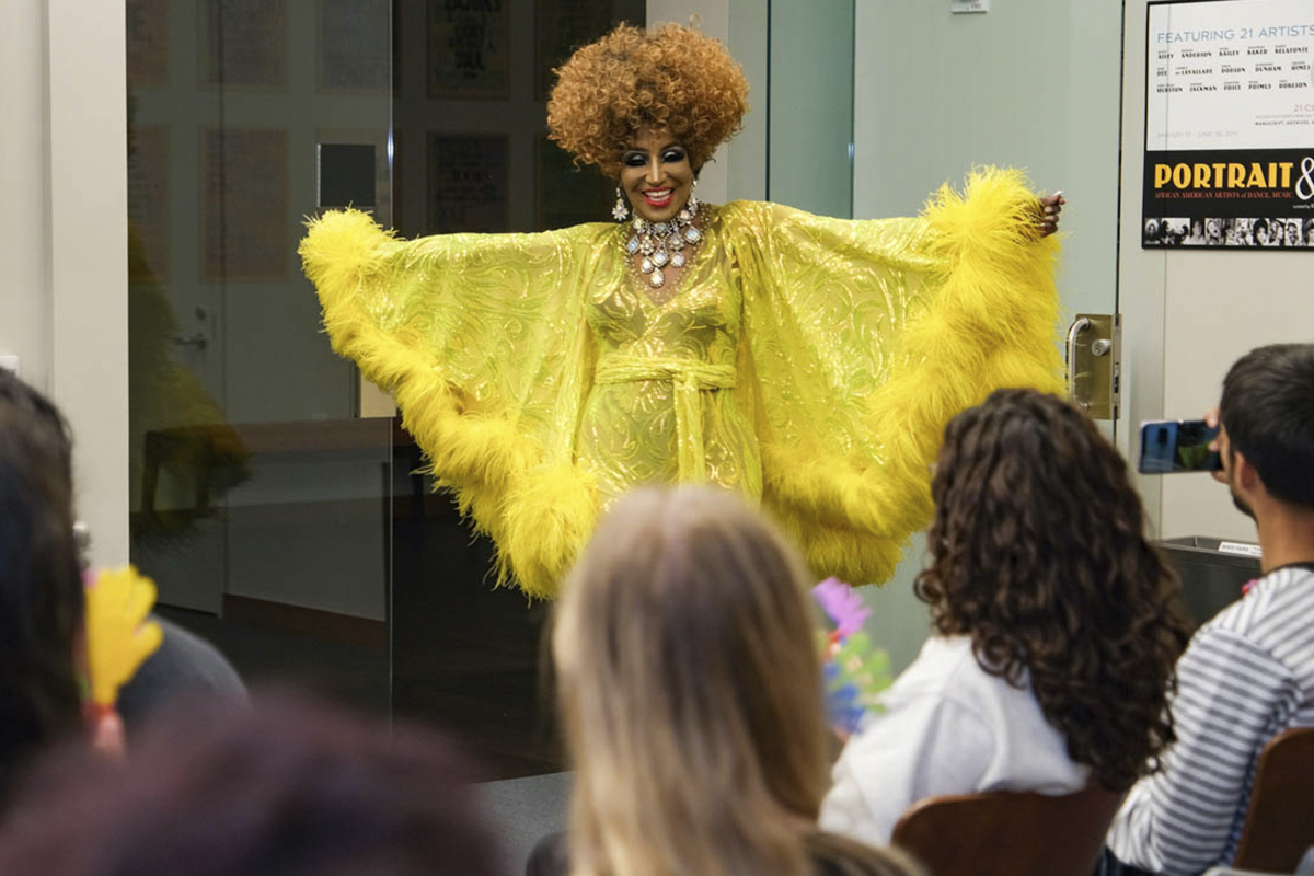 performer dressed in yellow costume and red curly wig