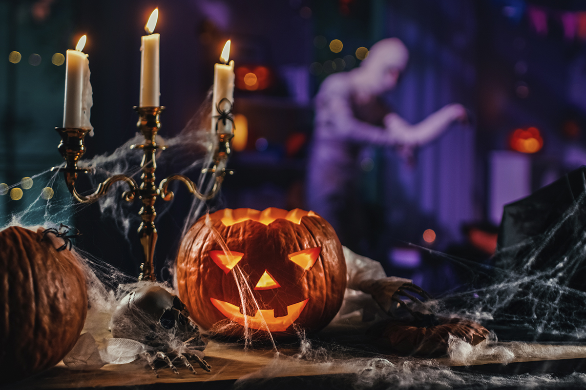 man with monster statue hovering over his shoulder