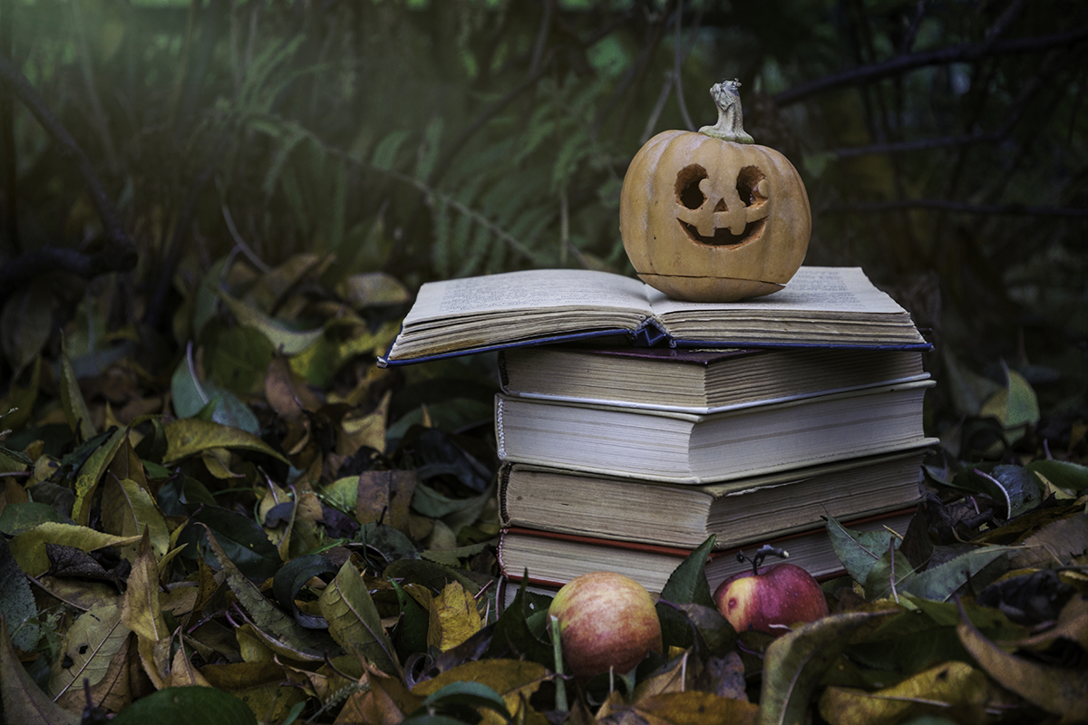 Stock image of a pumpkin on a stack of books