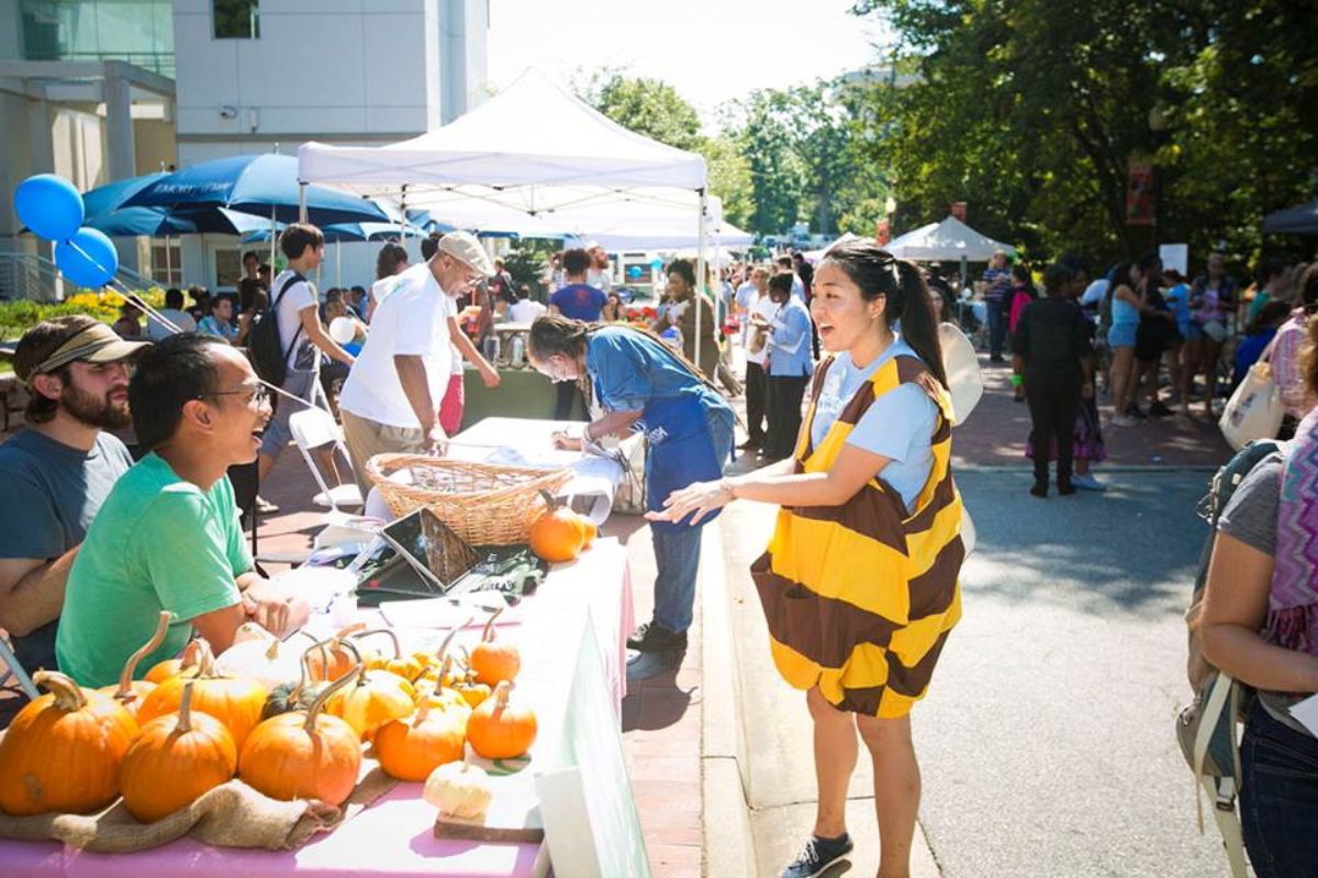 student dressed as a bee at a food fair