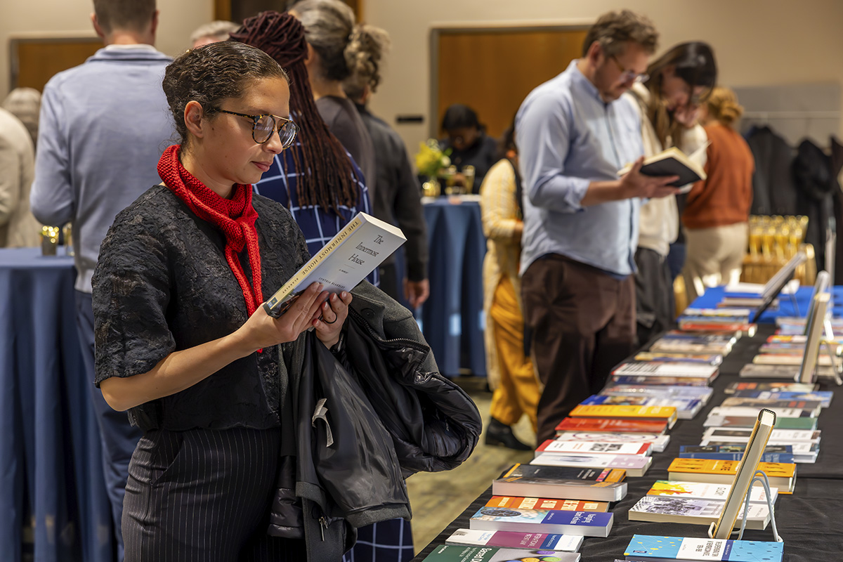 woman reading the back cover of a book