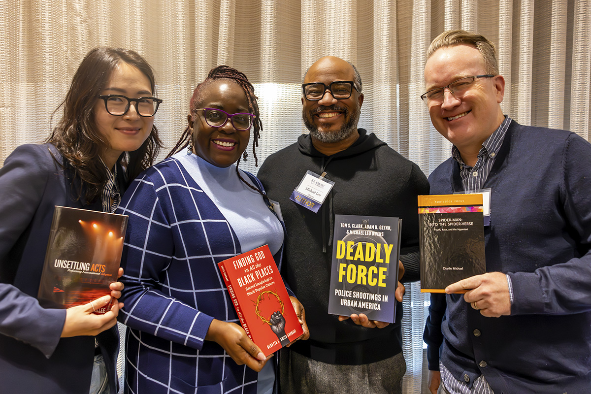 four authors holding their books